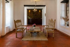 查查波亚斯La Xalca Hotel - Asociado Casa Andina的客厅配有桌椅和吊灯。