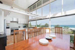 阿波罗湾最美瑞度假屋的开放式厨房和带大玻璃窗的用餐室