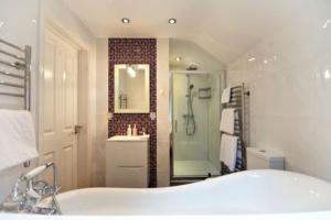 UplymeAcorns with own hot tub, romantic escape, close to Lyme Regis的带浴缸、淋浴和盥洗盆的浴室