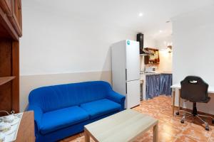 FasniaFinca Lucrecia的客厅配有蓝色沙发,设有冰箱