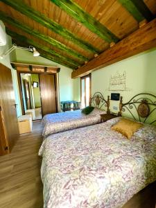 夸科斯德尤斯特Casa Rural Juan de Austria的一间卧室设有两张床和木制天花板