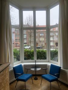 马斯特里赫特HS68-apartment的大窗户前的两把椅子和一张桌子
