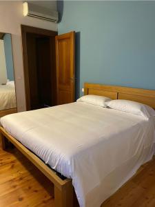 斯特拉Bed and Breakfast Ca’ Pisani的卧室配有一张白色大床和木制床头板