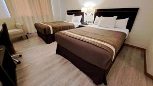 库里科库里科阿尔马格罗迪亚哥酒店的酒店客房,配有两张床和椅子