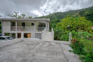 Rivière-PiloteCharmant logement F3 au sud de la Martinique (PMR)的白色的房子,有栅栏和车道