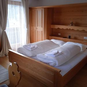 马莱斯韦诺斯塔Apartement Noggler Zimmer mit Frühstück的一张带白色毛巾的床,配有窗户