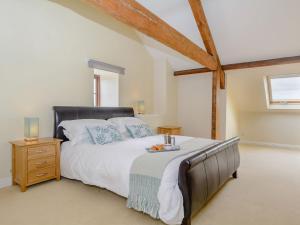 北伍顿Mulberry Cottage的一间卧室设有一张大床和一个窗户。
