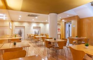 格拉纳达Hotel Macià Plaza的用餐室配有桌椅
