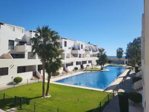 Playas de VeraApartamento con vistas al mar y piscina comunitaria en Residencial Alborada!的一个带游泳池和大楼的公寓