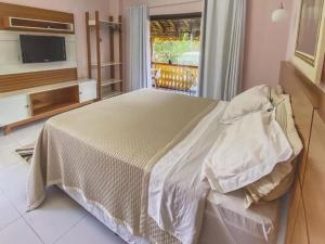 Mimoso do SulCanto de Roca Turismo e Lazer的一间卧室配有一张大床和电视