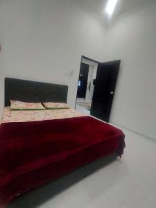 巴西富地Homestay ainnor的一间卧室配有一张红色大床和镜子