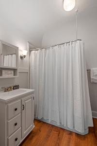 SpringfieldThe Hartness House的浴室设有白色的淋浴帘和水槽