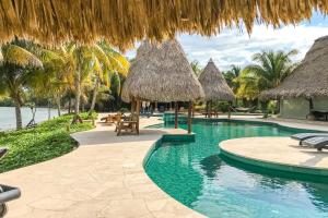 霍普金斯Villa Fiesta at Morningstar Breeze Gold Standard Certified的一个带茅草伞的游泳池的度假酒店