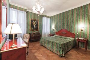 威尼斯帕拉索香东皮亚诺安蒂科酒店的一间卧室配有床和绿色壁纸