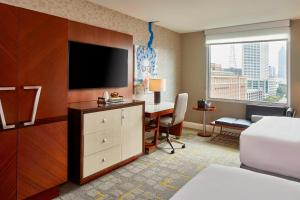 亚特兰大亚特兰大中城万丽酒店的酒店客房配有一张床和一张书桌及一台电视
