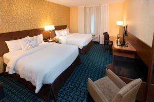 底特律莱克斯Fairfield Inn & Suites by Marriott Detroit Lakes的酒店客房配有两张床和一张书桌