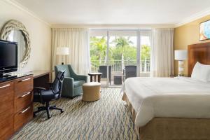 迈尔斯堡Marriott Sanibel Harbour Resort & Spa的酒店客房,配有床和电视
