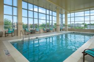 阿林顿巴尔斯顿阿林顿万豪原住酒店的一座带蓝色椅子和窗户的游泳池