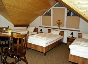 下乌斯奇基Noclegi Helvet的一间卧室设有两张床、一张桌子和一个窗口