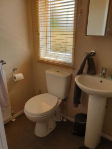 弗福尔Kimadalyn的浴室配有白色卫生间和盥洗盆。