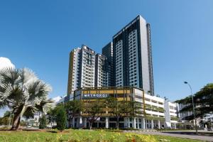 大山脚Metropol Serviced Apartment - Bukit Mertajam的一座大型办公楼,前面有棕榈树