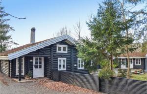 霍恩拜克Pet Friendly Home In Hornbk With Kitchen的一间黑色的房子,有白色的门和栅栏