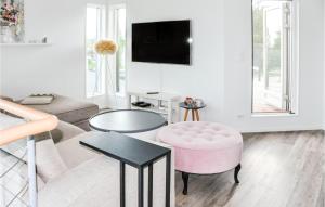 卡尔斯塔德5 Bedroom Beautiful Home In Karlstad的客厅配有粉红色的椅子和桌子