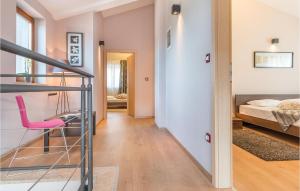 Heki4 Bedroom Awesome Home In Trosti的走廊设有粉红色椅子和一间卧室