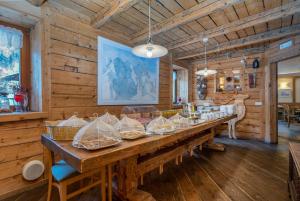 瓦尔布鲁纳Valbruna Inn Bed & Breakfast的木墙客房内的大木桌