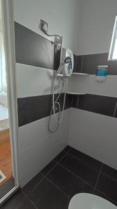务边Gopeng Serumah Holiday House的浴室设有黑白墙淋浴。