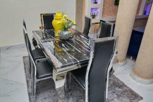 库马西Pomaa Villa的一张餐桌,上面有黄色花瓶