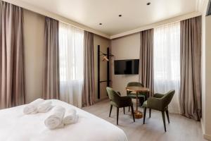 图尔La Loge Gogaille - Corneille - Accès autonome的酒店客房带一张床、一张桌子和椅子