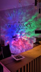 加茨比亚格拉Willa Sky的配有一张桌子和壁画的房间