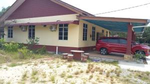 Kampong Wakaf TengahMufeed Homestay的停在房子前面的一辆红色面包车