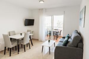 阿尔比尔Nacavi Albir Aparthotel的客厅配有沙发和桌子
