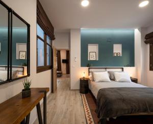 格拉纳达Santa Escolástica en pleno centro de Granada的一间卧室设有一张蓝色墙壁的大床