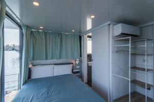LisanzaLa Dolce Vita House Boat的一间小卧室,配有床和窗户