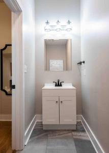 路易斯威尔Newly Renovated 3 Bedroom Shelby Park Home **FREE PARKING**的白色的浴室设有水槽和镜子