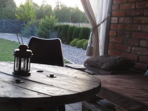 厄尔科Cudodomek SPA w Mrozach Wielkich koło Ełku的木桌、椅子、桌子和砖墙