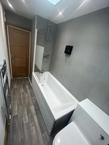 伯明翰Stylish 2 bed apartment.的白色的浴室设有浴缸和卫生间。