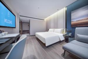 长沙长沙东塘亚朵酒店的一间酒店客房,配有一张床和一台电视