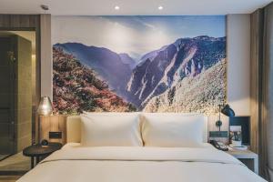 重庆重庆江北机场亚朵酒店的一间卧室配有一张壁画床