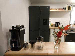 Oasis at Burringbar waterfront holiday的厨房配有咖啡设施和黑冰箱。