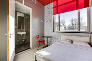 阿姆斯特丹ClinkNOORD旅舍的一间卧室设有一张床和红色天花板