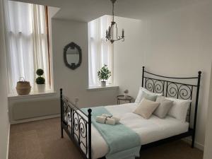 格拉斯哥Inviting 1-Bed Apartment in Merchant City的卧室配有黑色和白色的床以及白色枕头。