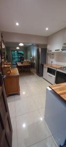 彼得马里茨堡Forest View Cottage的一间铺有白色大瓷砖地板的大厨房