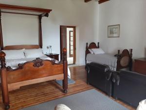 斯泰伦博斯Mooiplaas Wine Estate的一间卧室配有两张床和一张沙发。
