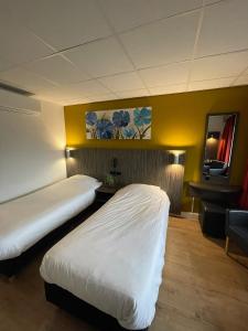蒂尔堡蒂尔堡城市酒店的酒店客房配有两张床和一张书桌