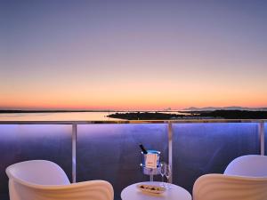 埃斯普霍斯Five Flowers Hotel & Spa Formentera的日落时分带桌椅的阳台