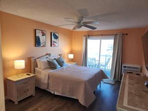 大洋城Beachfront Condo In Paradise的一间卧室配有一张床和吊扇